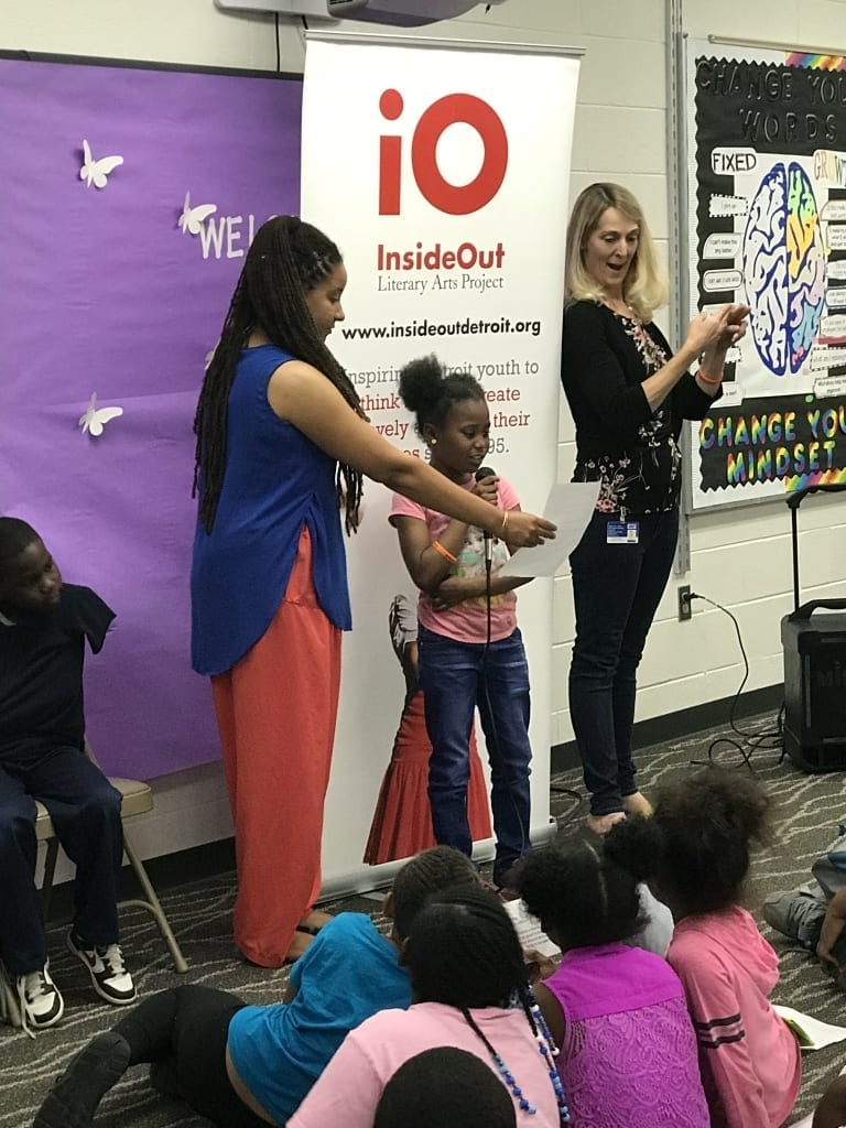 Child reading poem as part of InsideOut Literary Arts