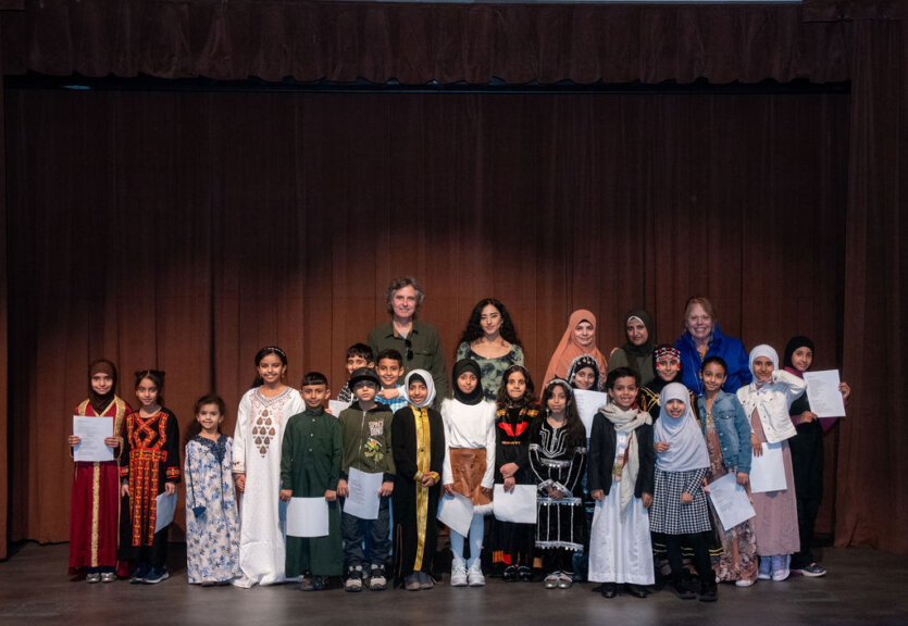 A group of InsideOut students from Salina Elementary stand onstage at the DIA at the Arab American Culture in Verse reading in 2024.